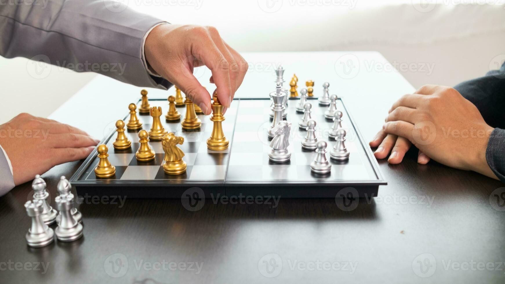 Young businessman planning winning chess move in game of chess representing successful and victorious business path. chess concept representing strategic business strategy to achieve victory. photo