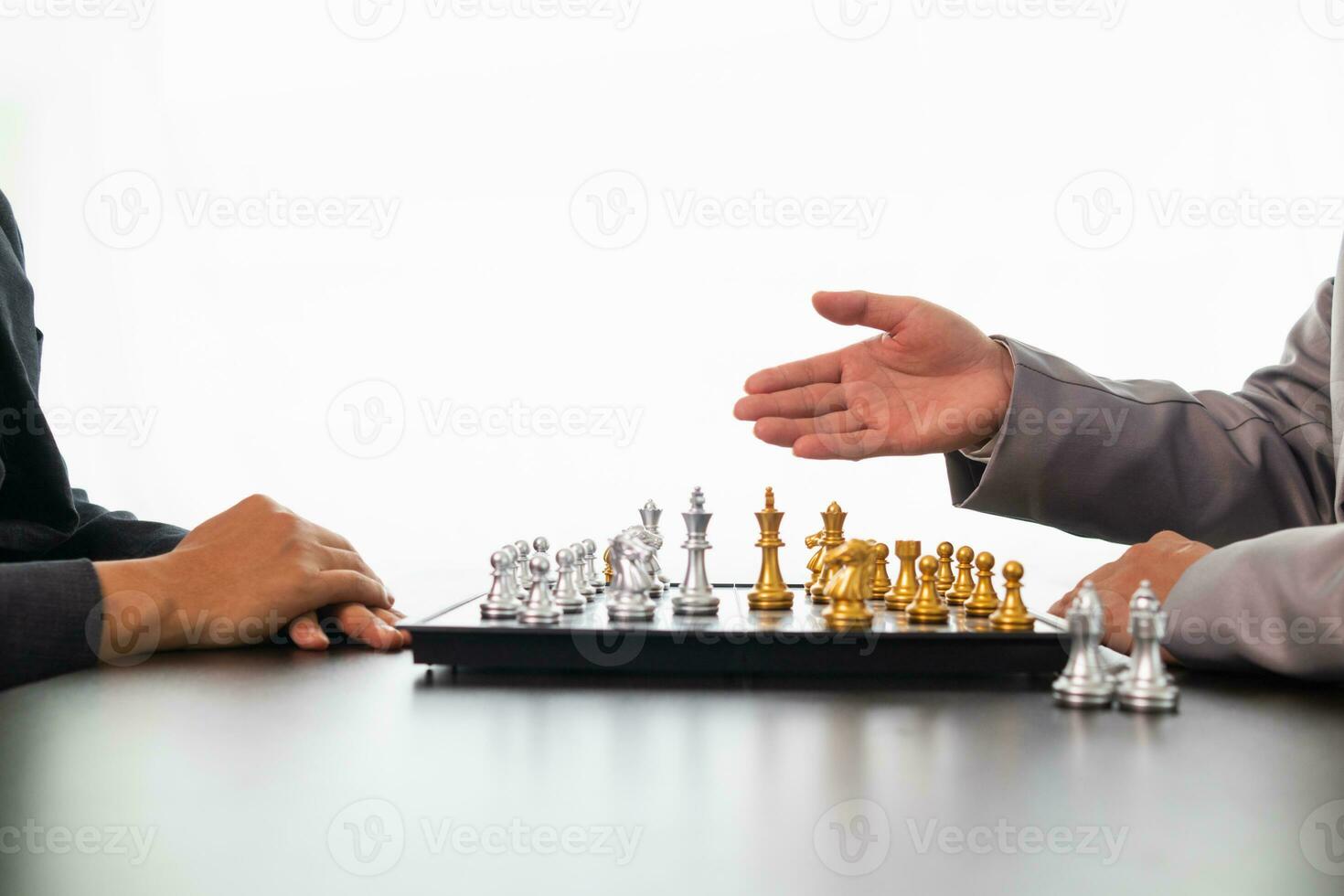 Young businessman planning winning chess move in game of chess representing successful and victorious business path. chess concept representing strategic business strategy to achieve victory. photo