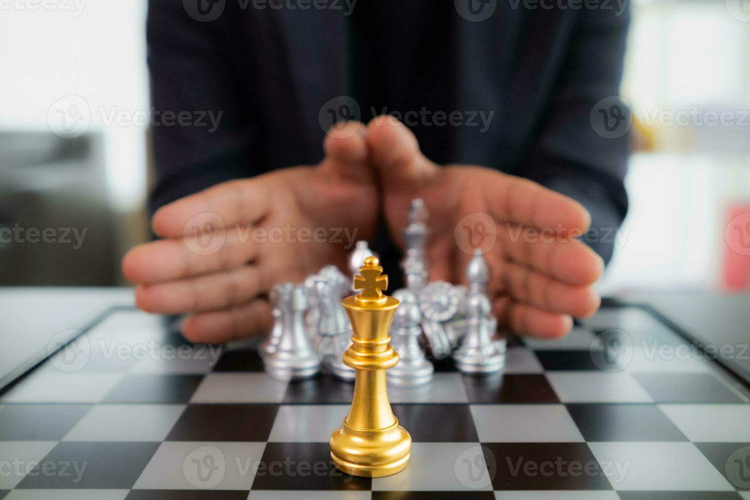 Young businessman planning winning chess move in game of chess representing successful and victorious business path. chess concept representing strategic business strategy to achieve victory. photo