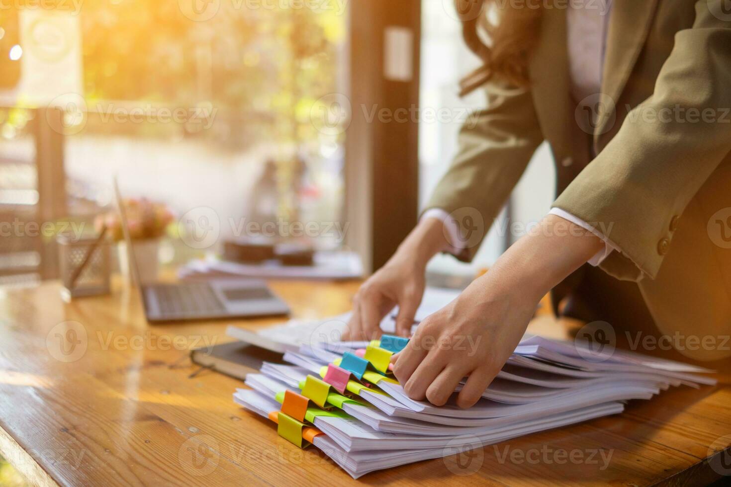 stack of documents on secretary desk were prepared It is legal document for real estate buyers to be used as evidence of possession. stacked papers were placed on the table awaiting examination. photo