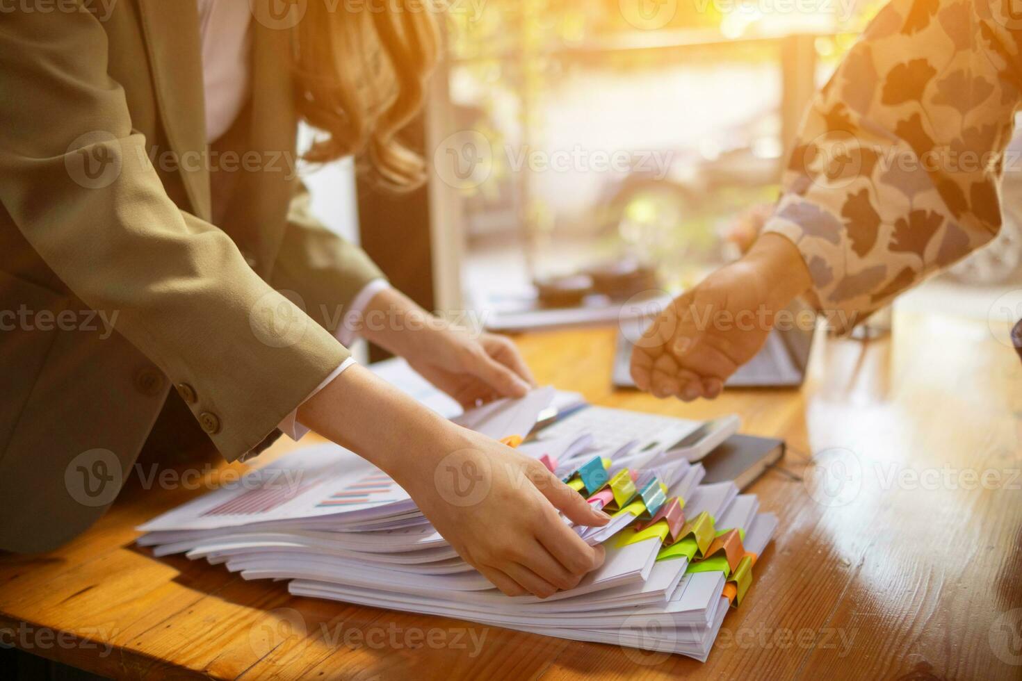 stack of documents on secretary desk were prepared It is legal document for real estate buyers to be used as evidence of possession. stacked papers were placed on the table awaiting examination. photo