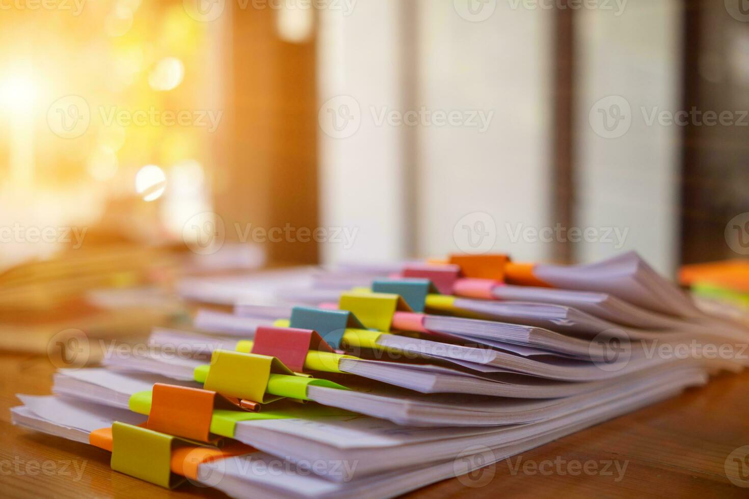 stack of documents on secretary desk were prepared It is legal document for real estate buyers to be used as evidence of possession. stacked papers were placed on the table awaiting examination. photo