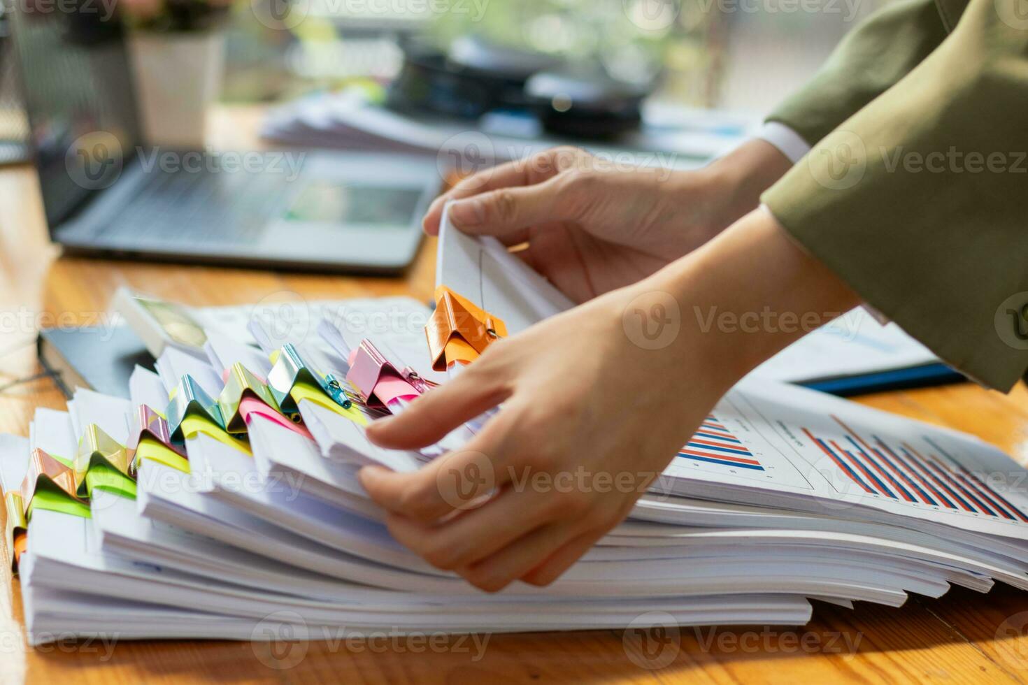 stack of documents on secretary desk were prepared It is legal document for real estate buyers to be used as evidence of possession. stacked papers were placed on the table awaiting examination. photo