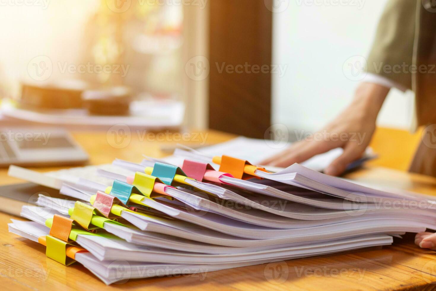 stack of documents on secretary desk were prepared It is legal document for real estate buyers to be used as evidence of possession. stacked papers were placed on the table awaiting examination. photo