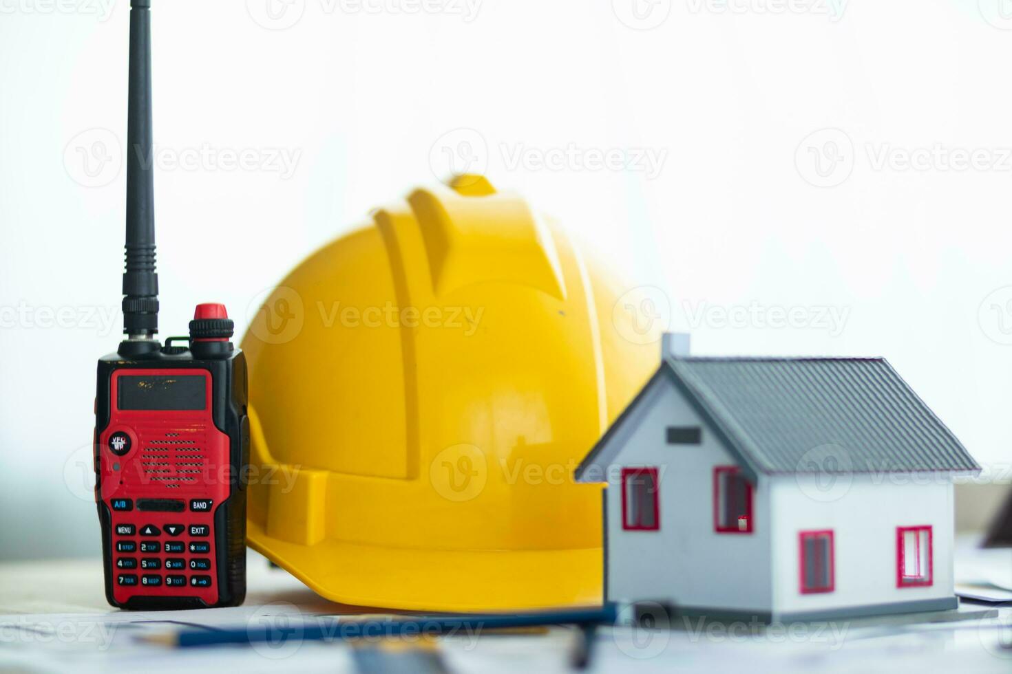 Yellow helmet were prepared for Construction engineers to wear before entering the construction area to prevent  danger of falling objects from working. Yellow safety helmet is placed on white table. photo