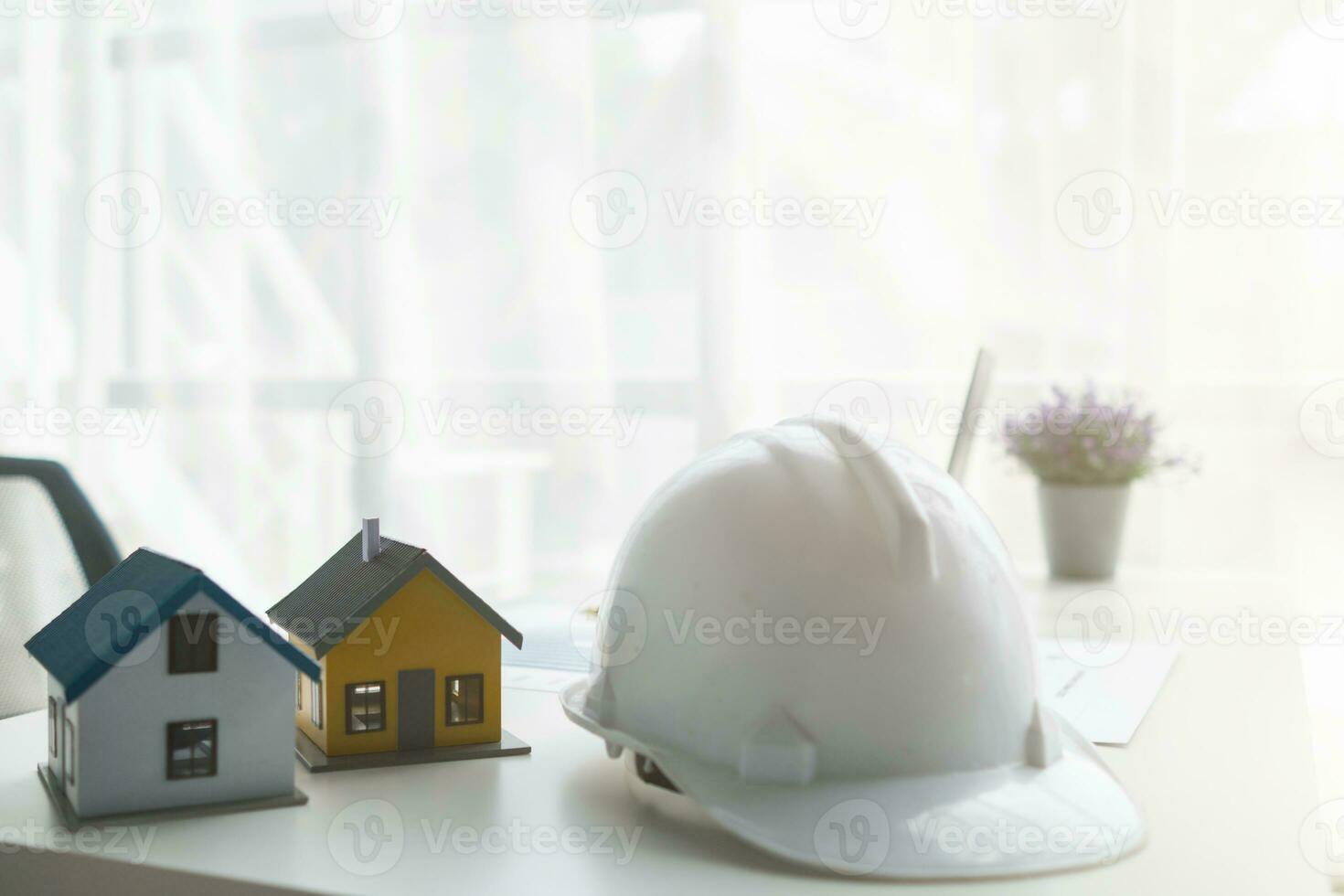 Construction engineers place plans and model homes  on desks in their offices for real estate agents to view the plans they want construction engineers to build on budget and meet client needs. photo