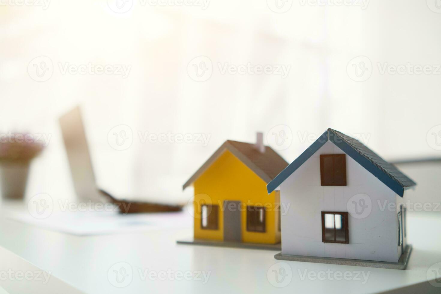 Construction engineers place plans and model homes  on desks in their offices for real estate agents to view the plans they want construction engineers to build on budget and meet client needs. photo