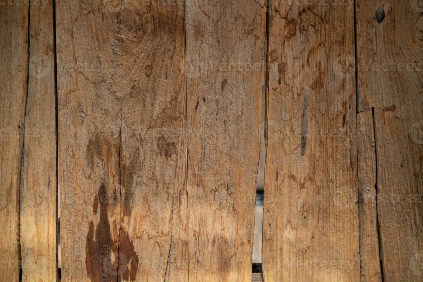 background old wooden wall that shows signs of cracking and deterioration from weather and age. Wooden wall backgrounds with natural textures are ideal for design and Copy Space backgrounds. photo