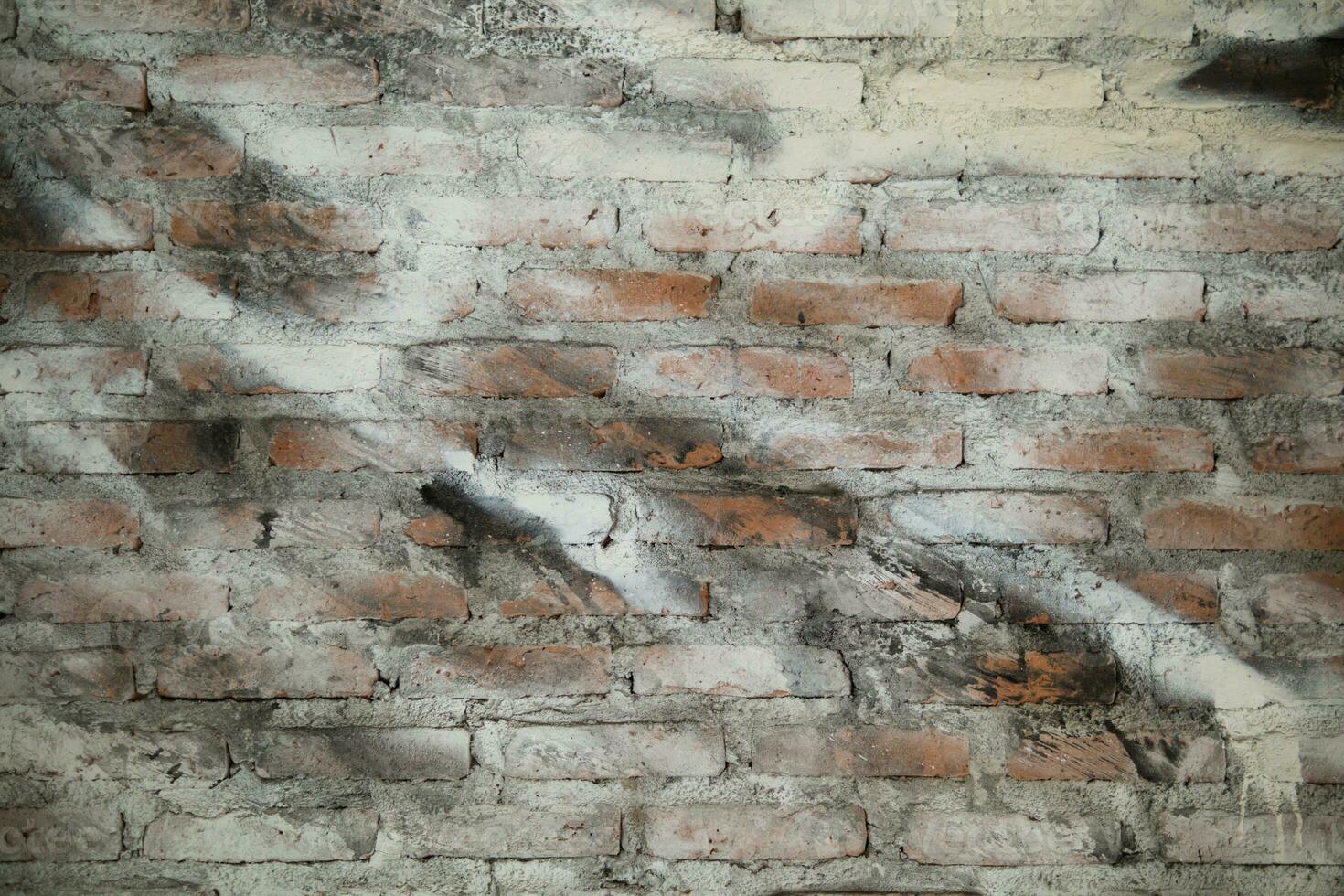 background old concrete wall that is waiting to be renovated by construction engineering team and brick wall background that is suitable for designers to use in their designs because it has Copy Space photo