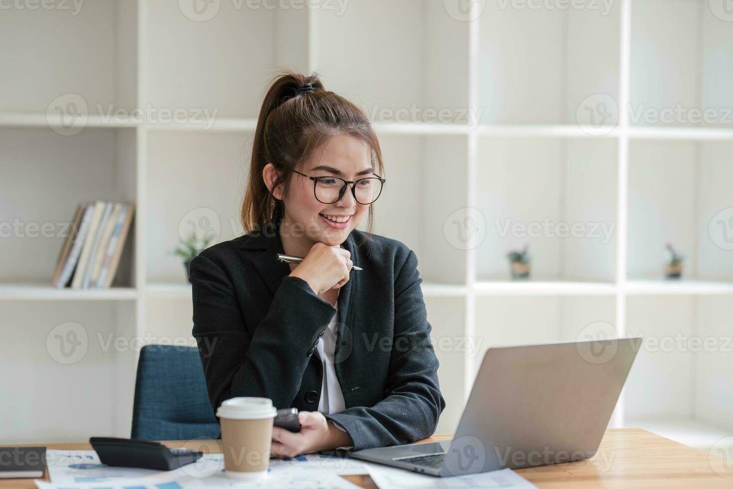 Asian businesswoman use laptop computer in office The Internal Revenue Service audit document balance calculation report is being prepared. photo