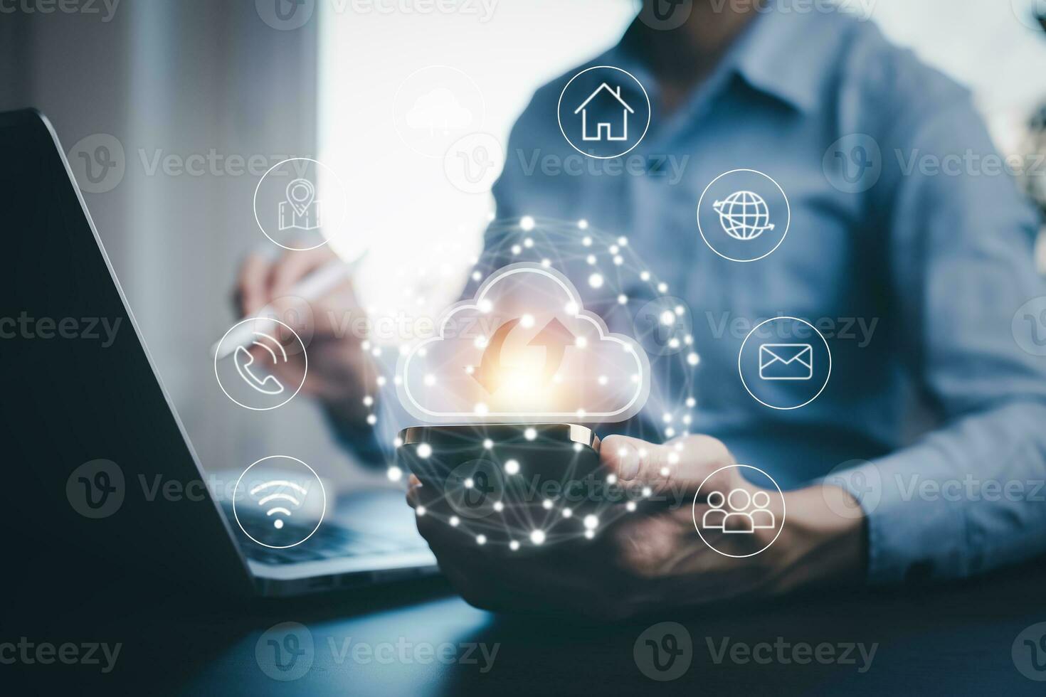Businessman hand holding smartphone and laptop with cloud computing diagram show on hand. Cloud technology. Data storage. Networking and internet service concept, Cloud sharing download and upload photo