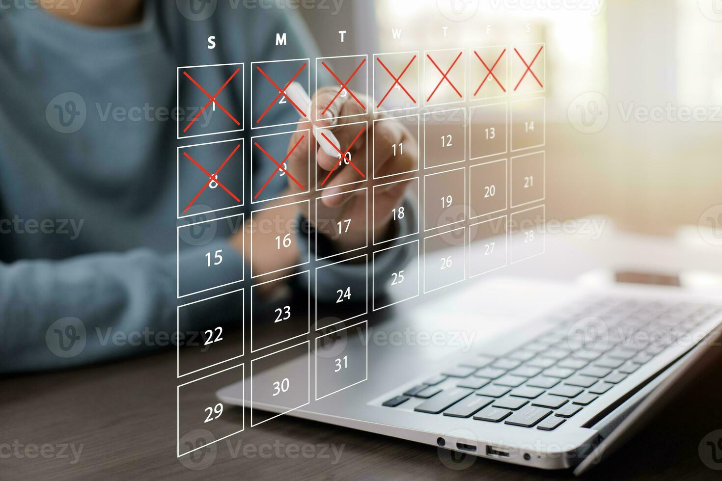 Business people use pen to write crossed-out online calendars and write a message on empty notebook paper while using a laptop to text messages, desktop view, Scheduling of meetings and appointments. photo