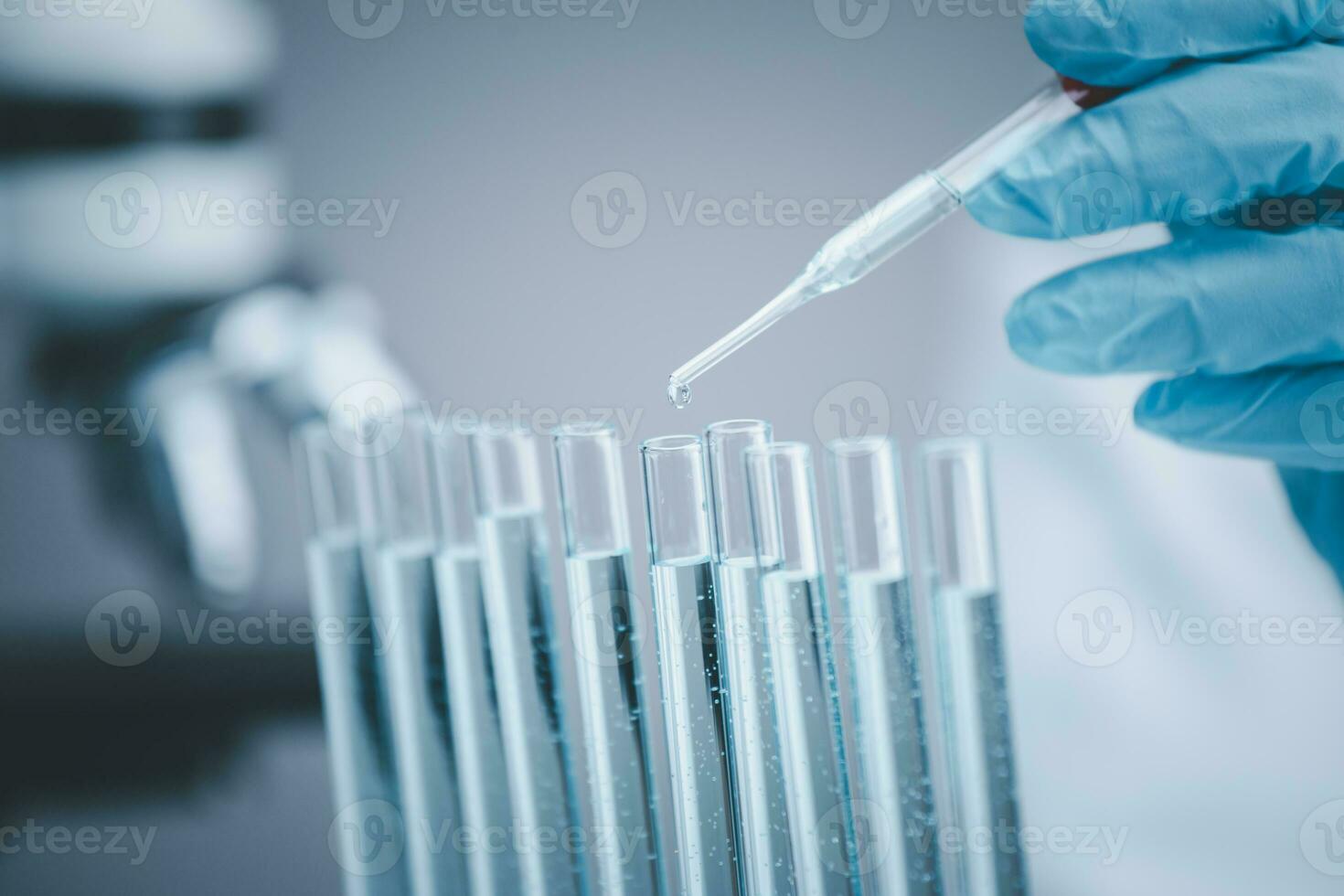 Microscope with lab glassware, nanotechnology conducting research fiber microfiber microbiology medicine healthcare pharma production lab laboratory science, drop-over test tubes in a research lab photo