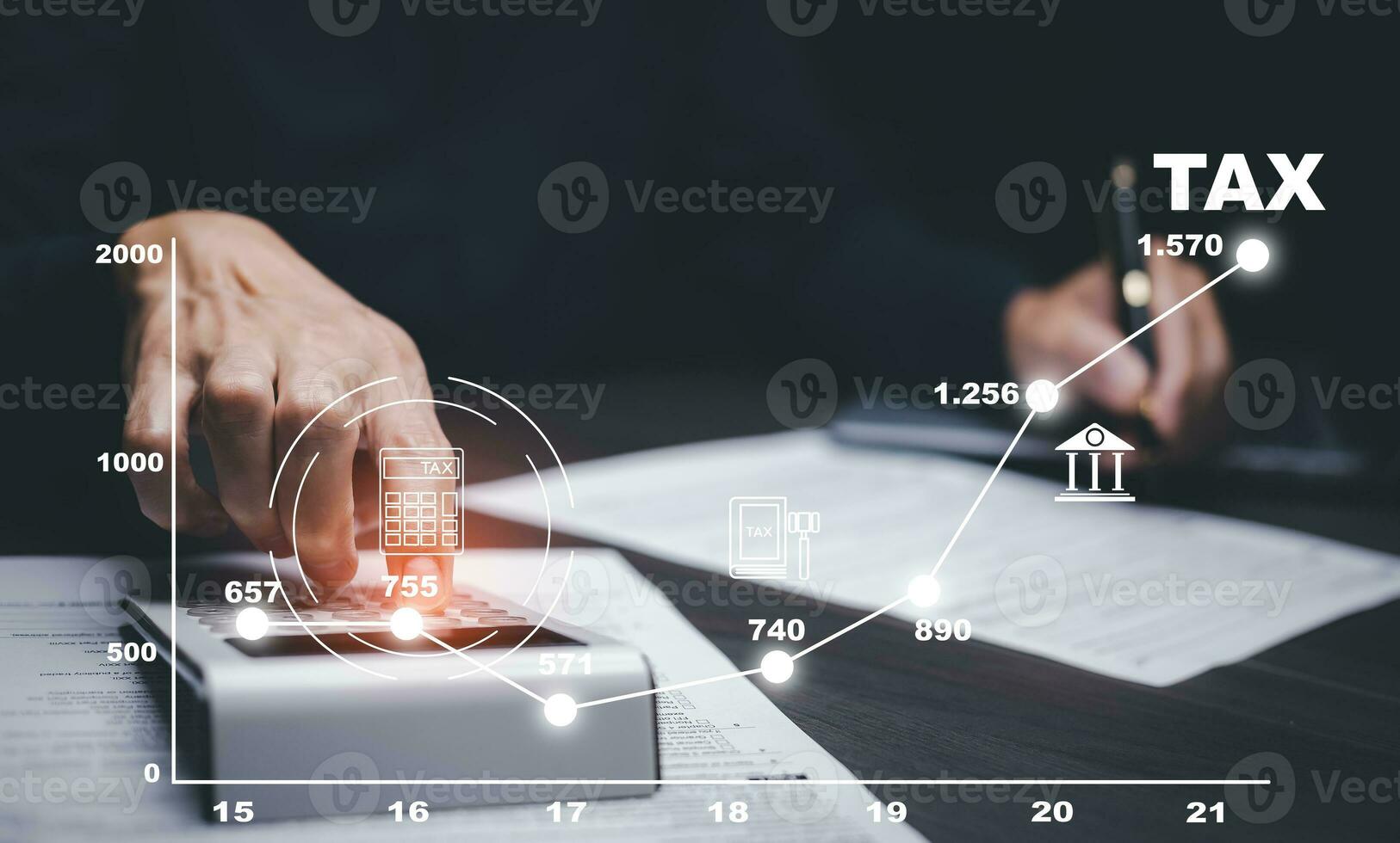 Concept of tax payment optimisation business finance,Man using calculator and taxes icon on technology screen,income tax and property, background for business, individuals and corporations such as VAT photo