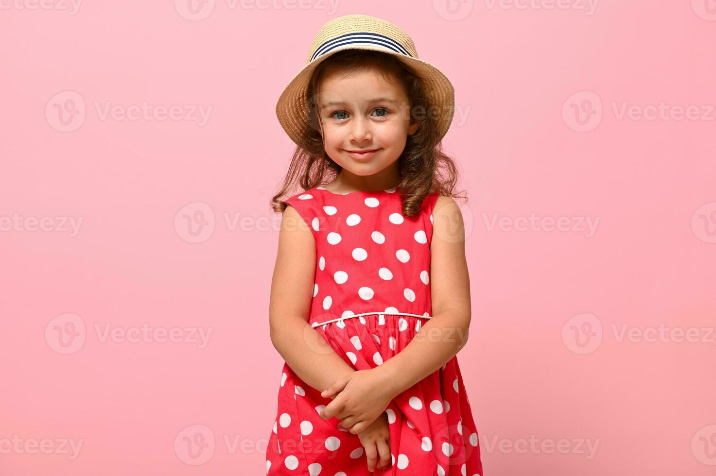 Little child kid baby girl 3-4 years old wearing pink polka dots dress and summer hat , isolated on pink background, children studio portrait. Mother's Day, love family, parenthood childhood concept photo