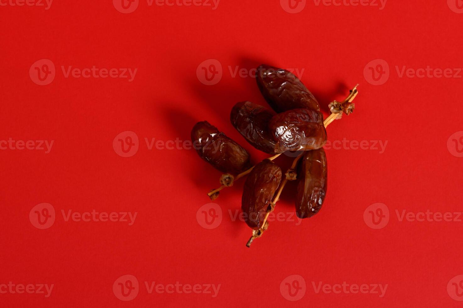 Flat lay with a branch of fresh tasty sweet dates for breakfast after interruption and fasting in Ramadan photo