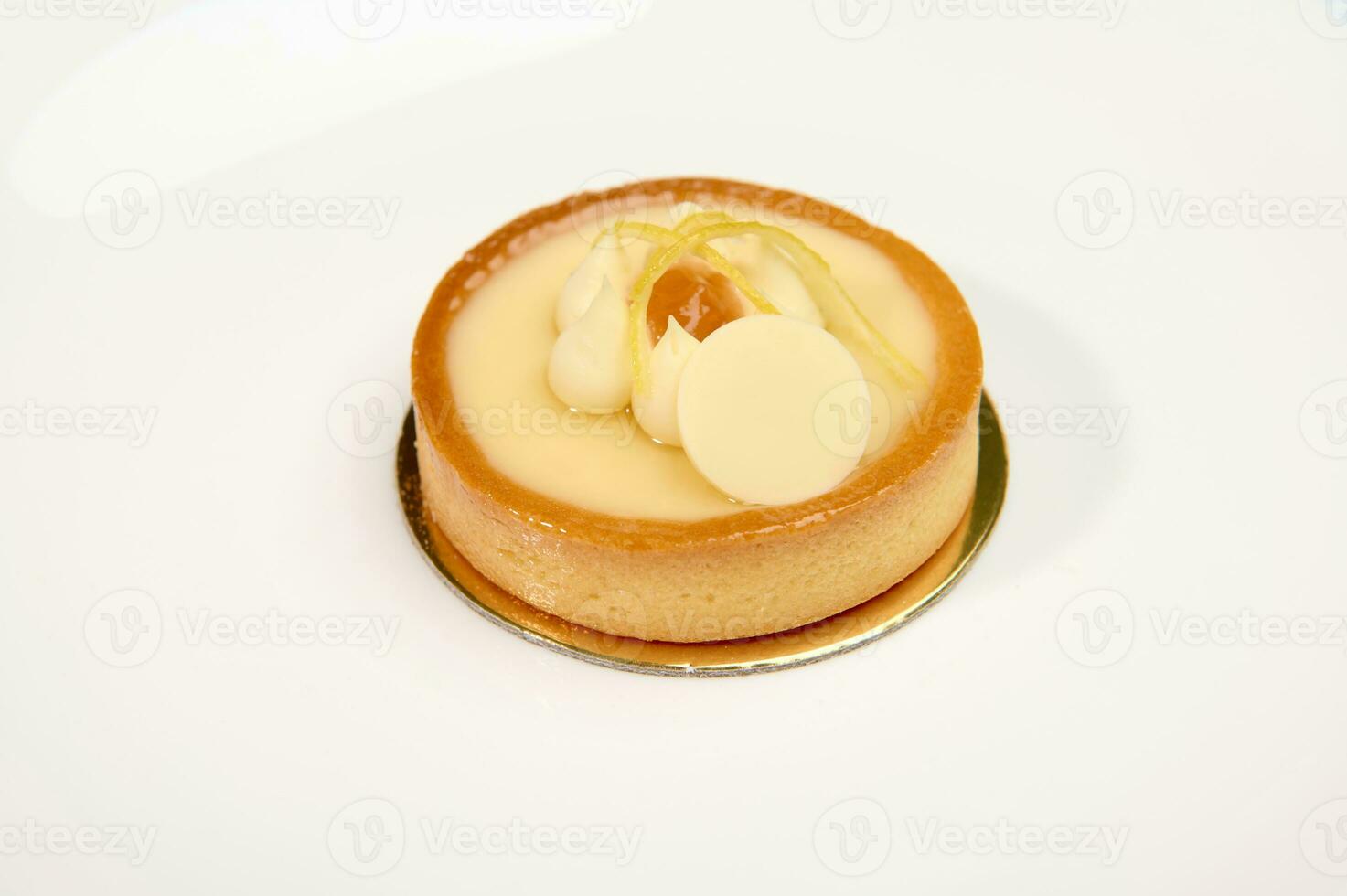 Still life with French sweet dessert a lemon cake, isolated over white background photo