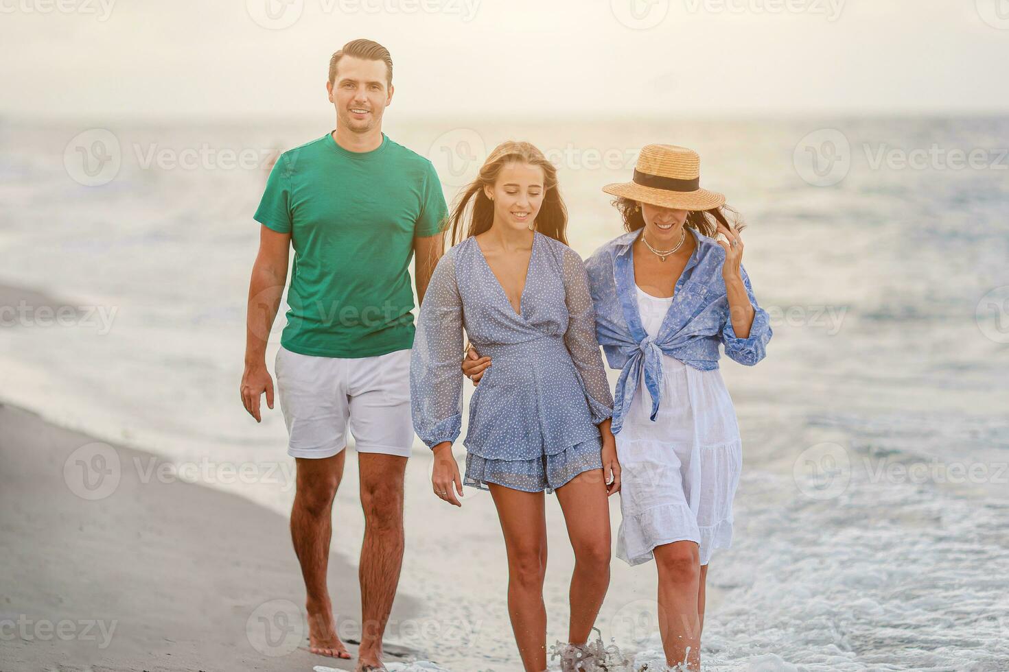 Happy family on the beach during summer vacation photo