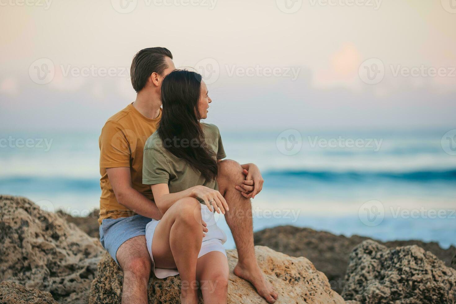 Young couple on the beach vacation in Florida at sunset photo