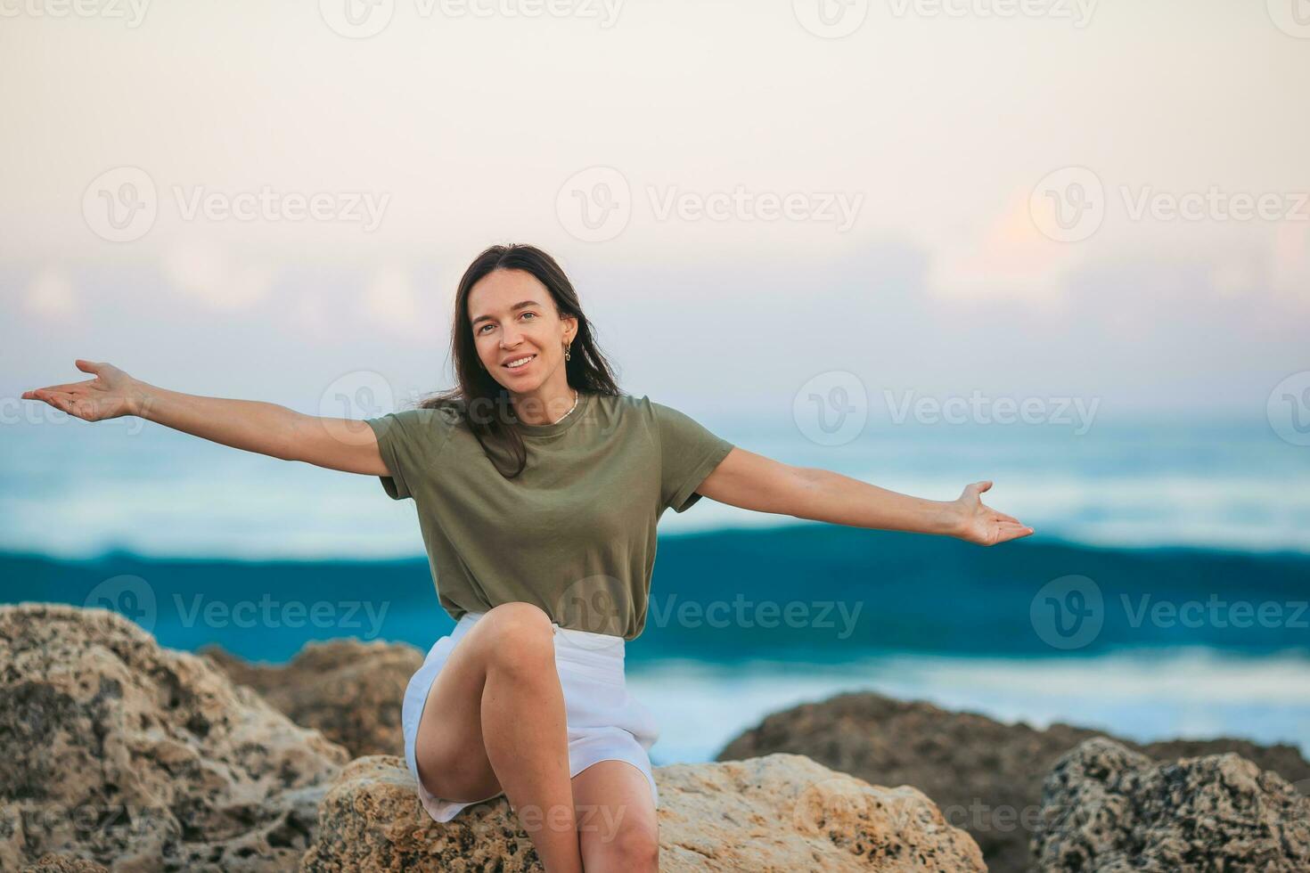 Young happy woman on the beach enjoy her summer vacation photo