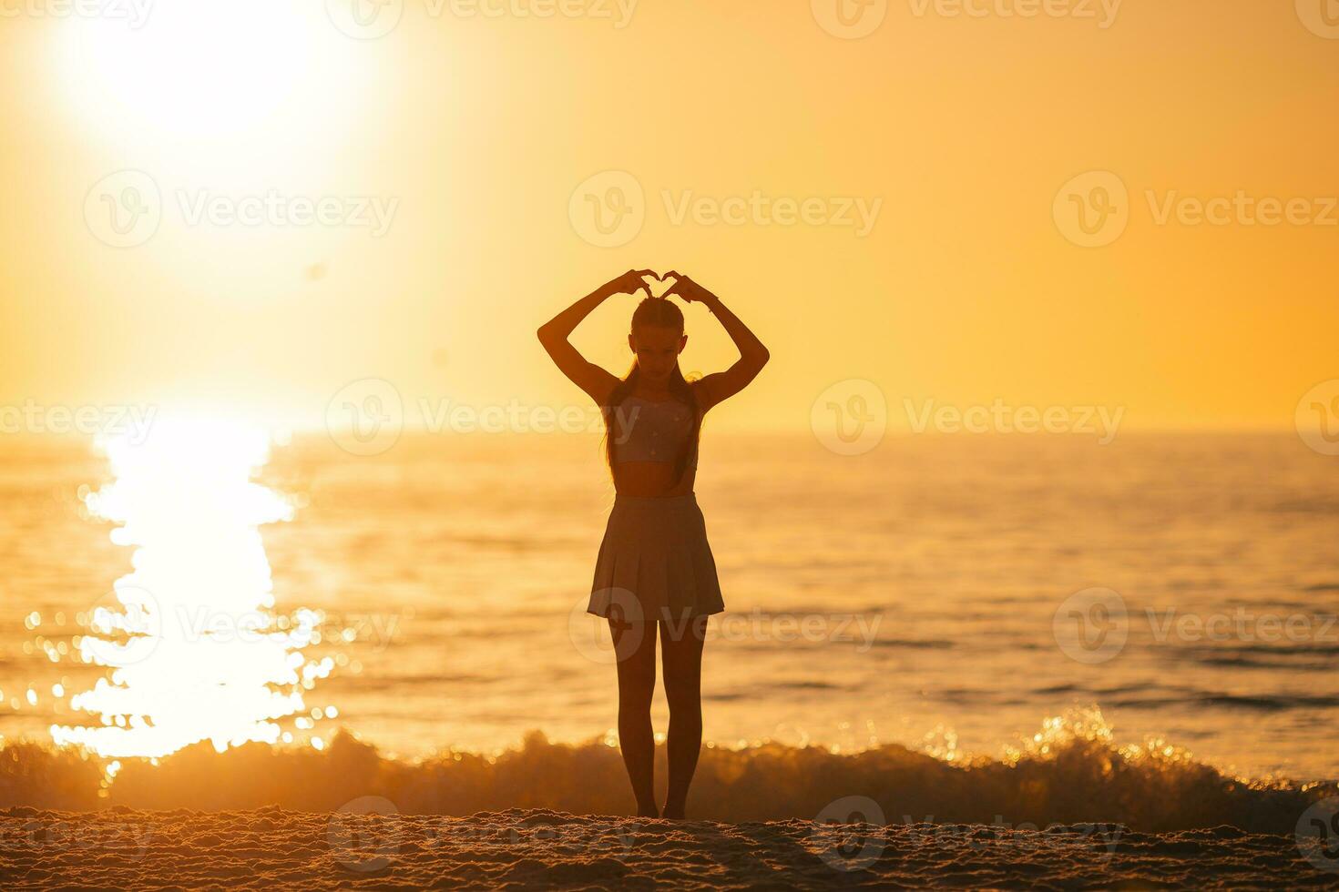 Happy teen girl enjoy tropical beach vacation at sunset photo