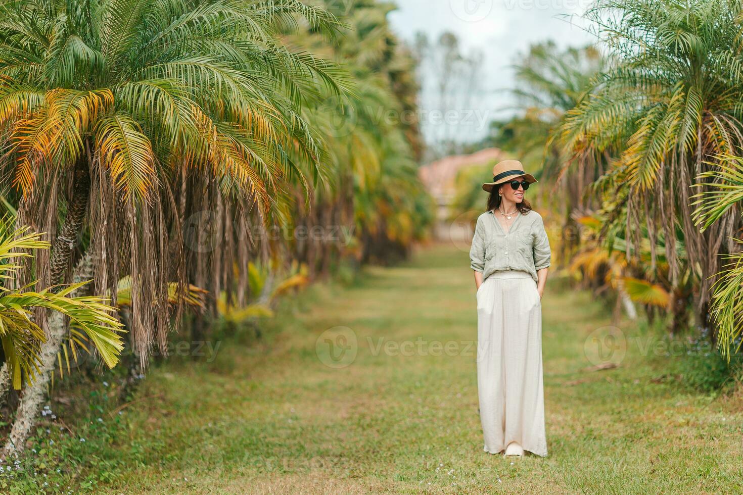 Young woman by palm trees photo