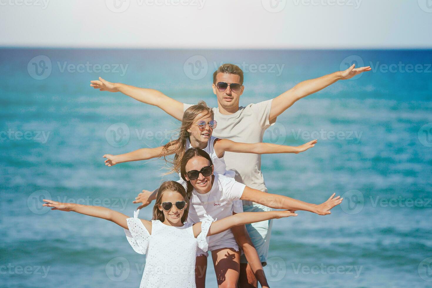 Happy family on the beach during summer vacation photo