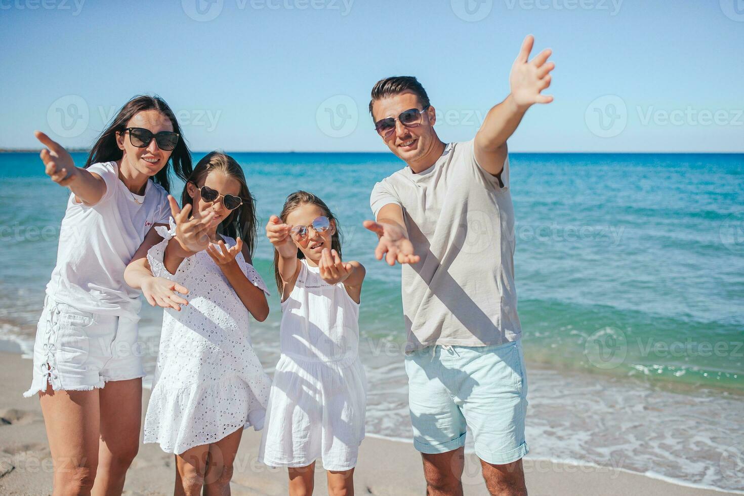 Happy family on the beach during summer vacation photo