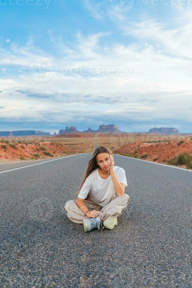 Scenic highway in Monument Valley Tribal Park in Utah. Happy girl on famous road in Monument Valley in Utah. photo