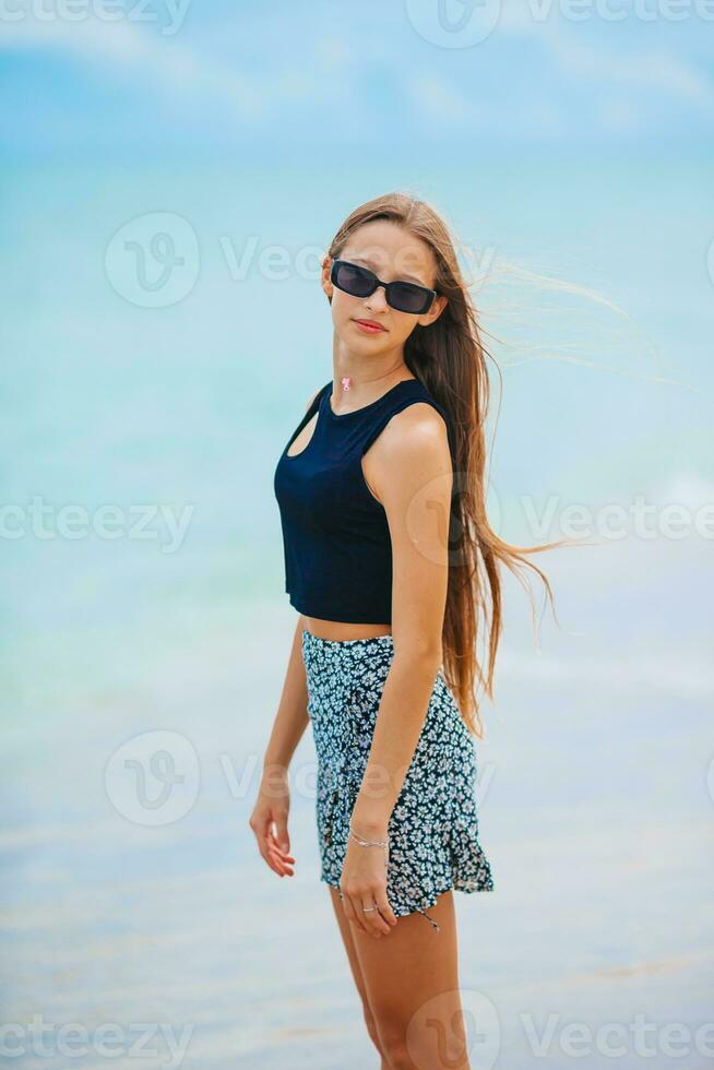 Happy young girl enjoy tropical beach vacation photo