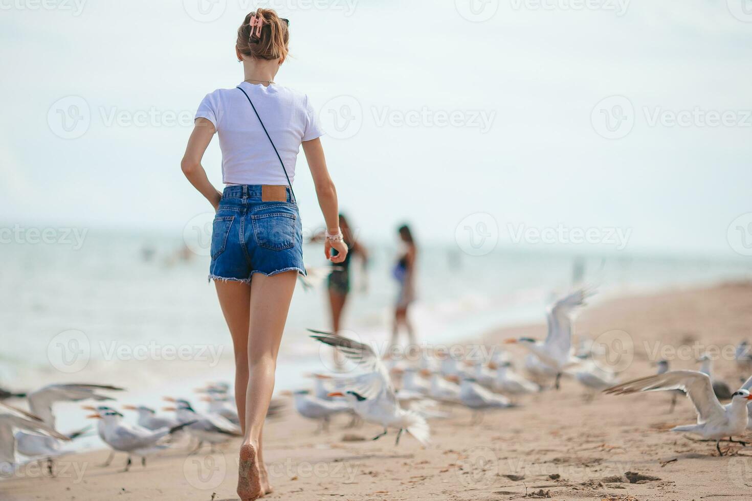 Adorable teen girl on the beach enjoy her summer vacation photo