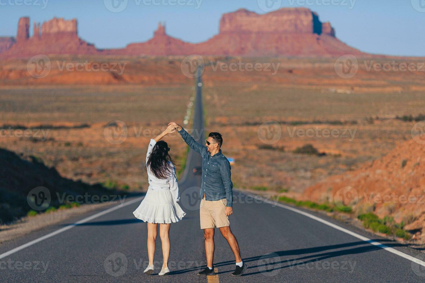 Happy couple on the famous road to Monument Valley in Utah. Amazing view of the Monument valley. photo