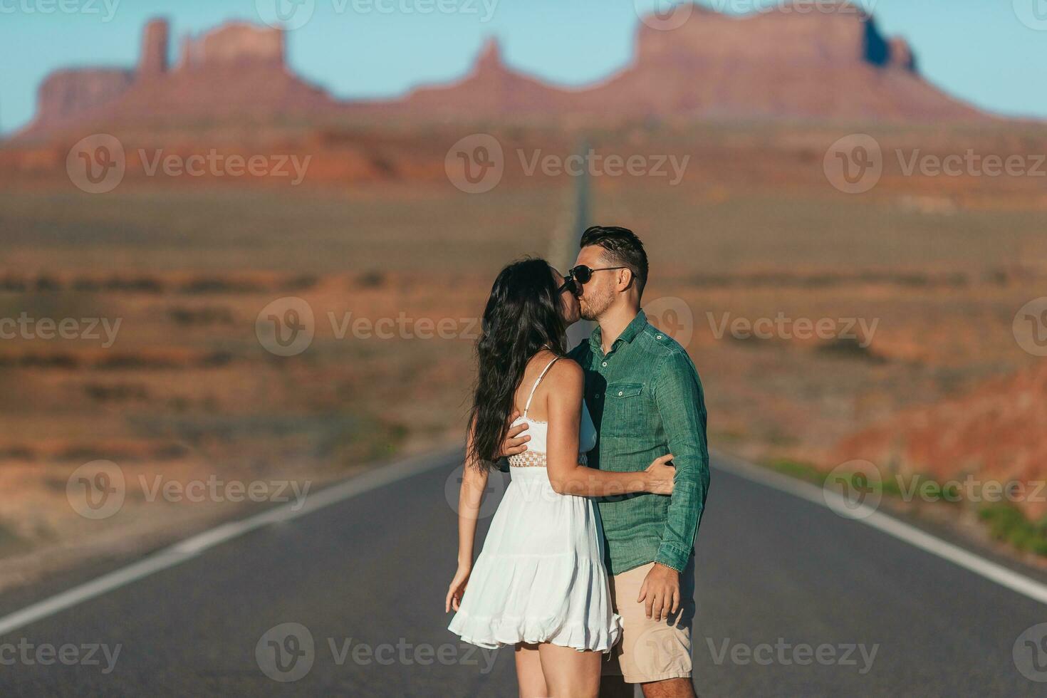 Happy couple on the famous road to Monument Valley in Utah. Amazing view of the Monument valley. photo