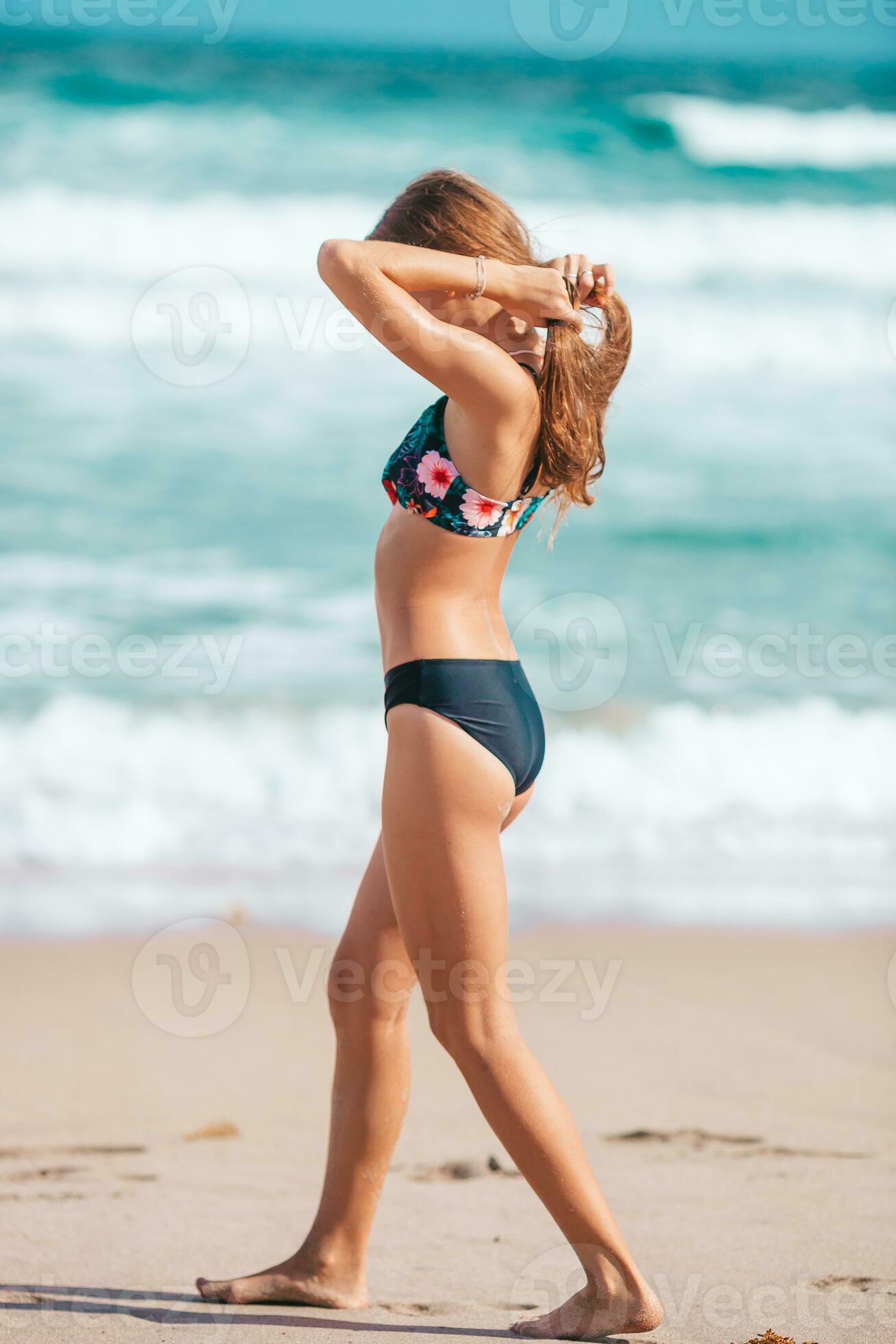 Adorable slim girl in a swimsuit with a perfect figure on the beach  30199936 Stock Photo at Vecteezy