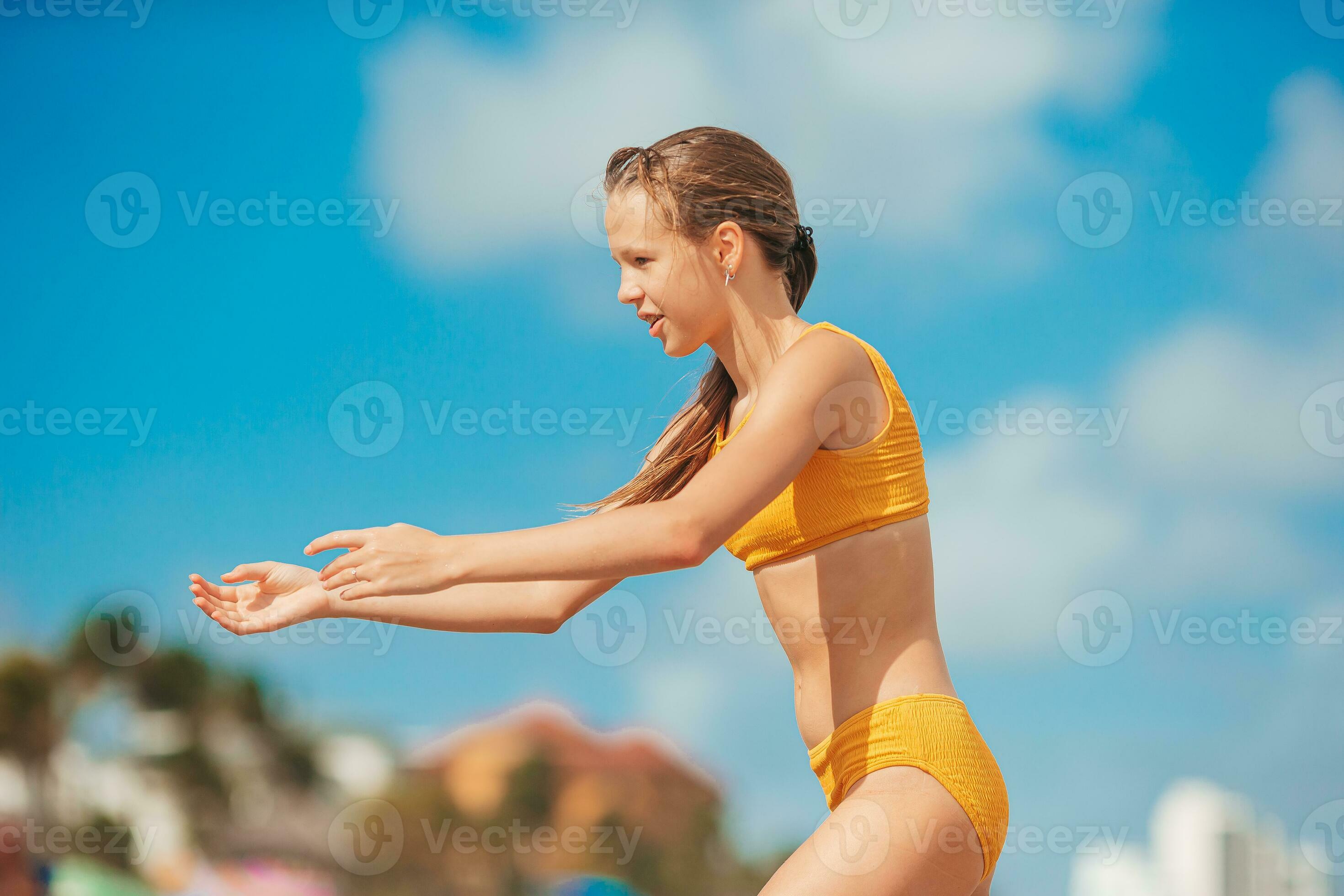 Adorable slim teen girl in yellow swimsuit on the beach 30199945 Stock  Photo at Vecteezy