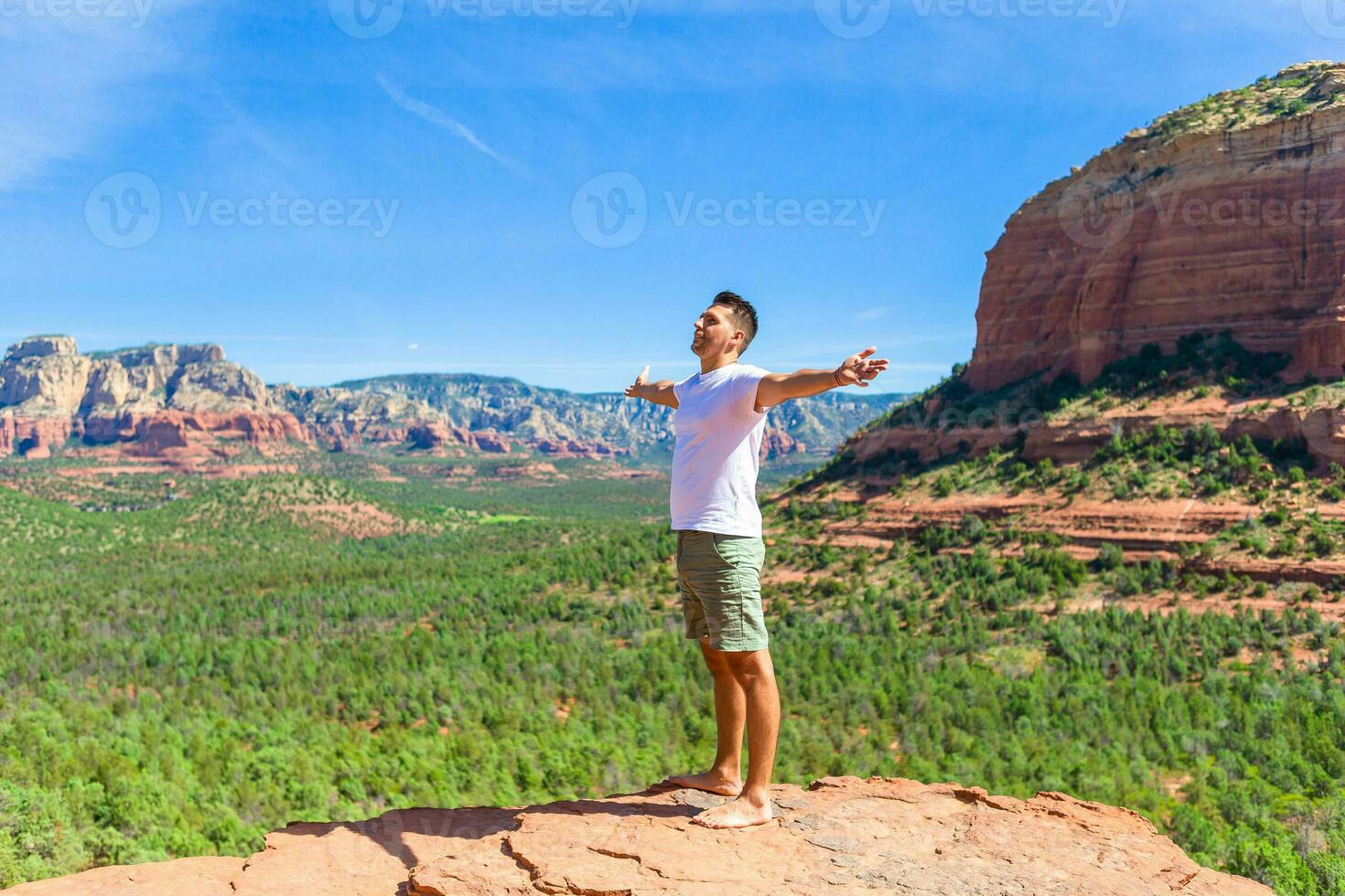Travel in Devil's Bridge Trail, scenic view panoramic landscape in Sedona, Arizona, USA. Happy young man on the famous trail in Sedona photo