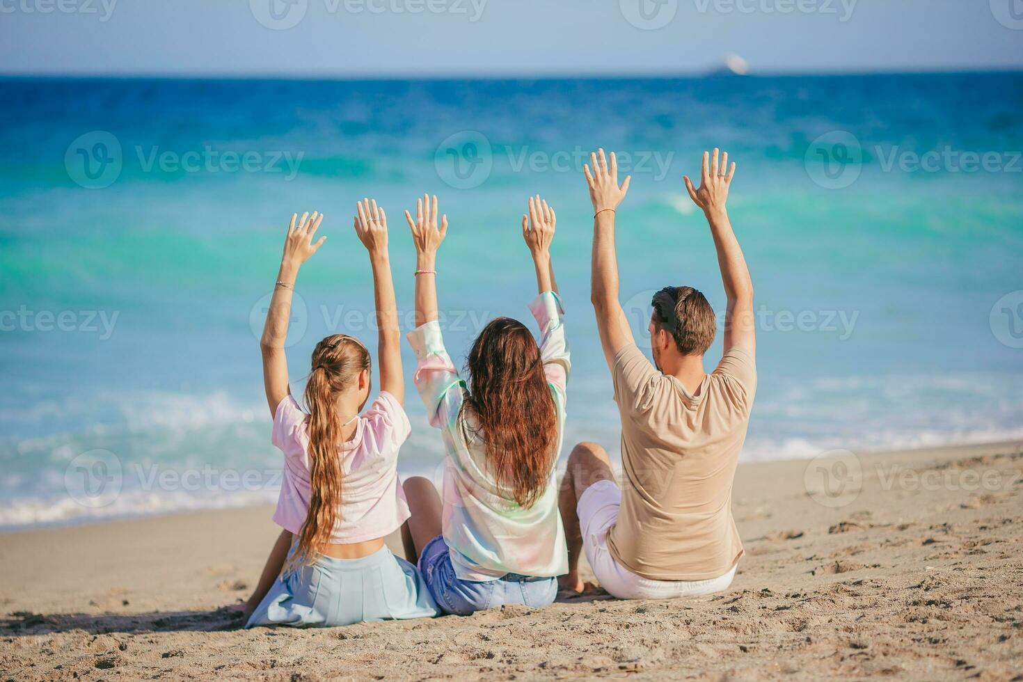 Family of three on the beach having fun together photo