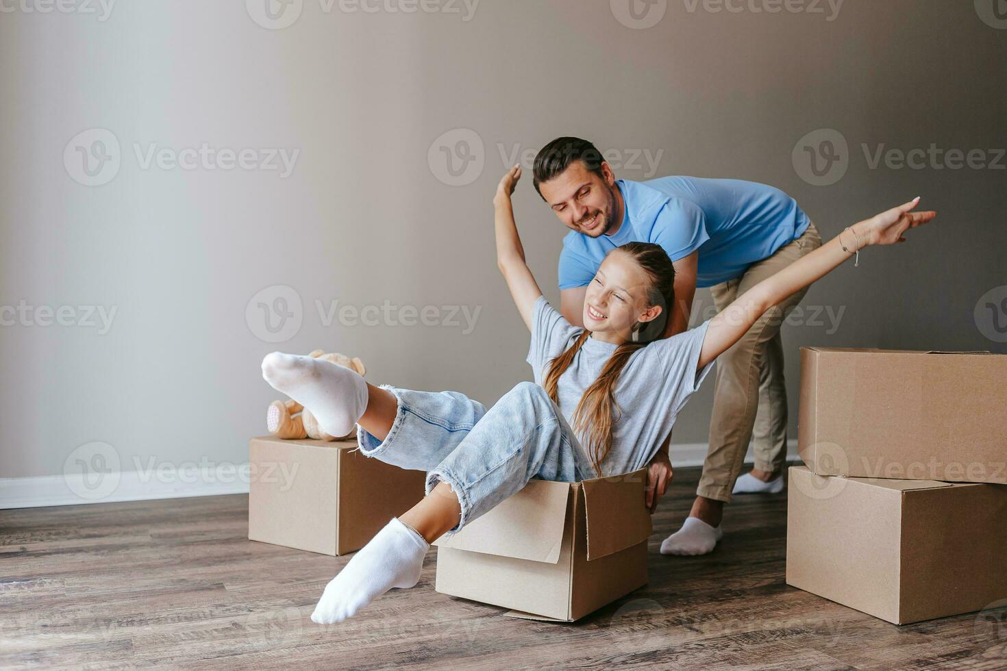 Family have fun on moving day in their new home photo