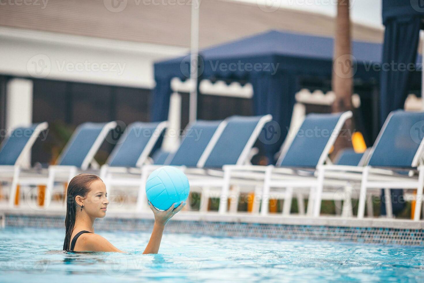 Teen girl swimming in pool photo