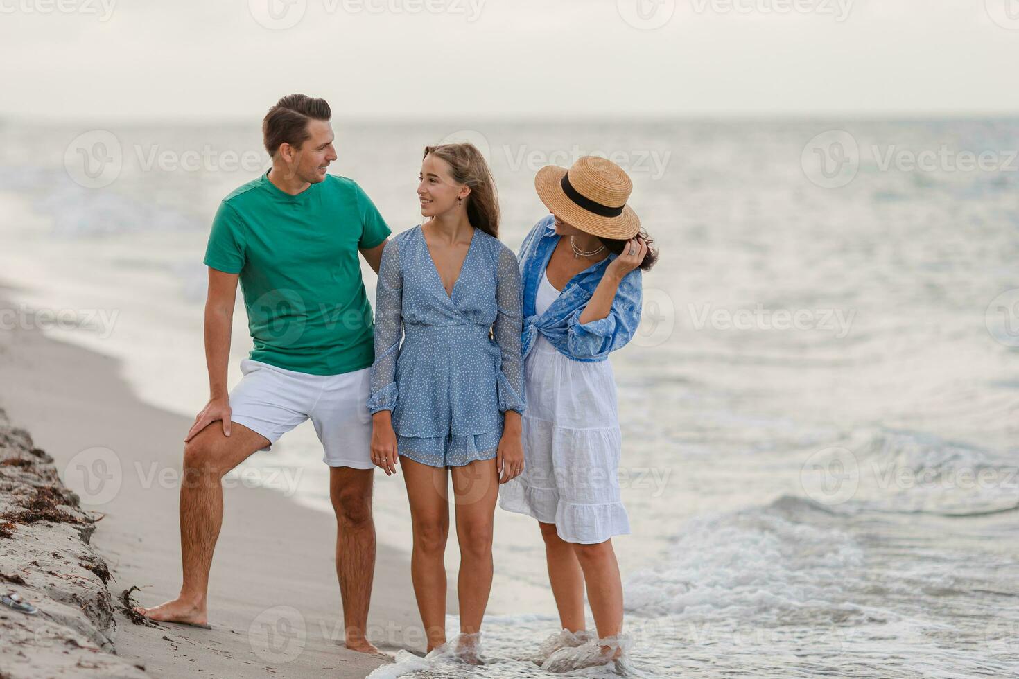 Happy family on the beach during summer vacation photo