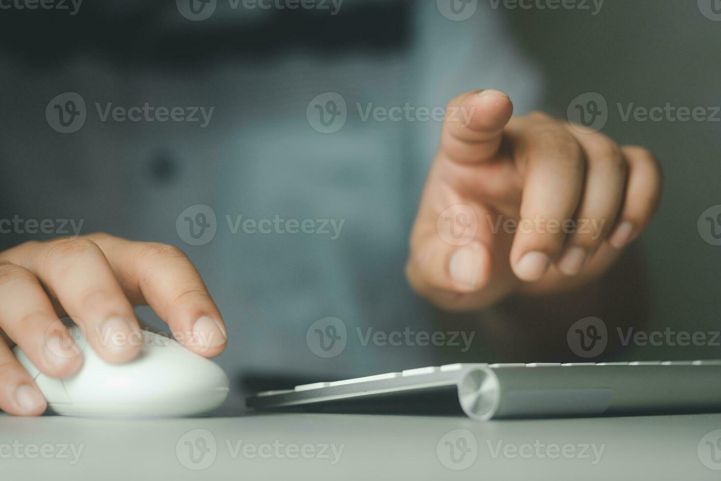 Businessman using computer mouse and pressing button on virtual screen. Man pointing. photo