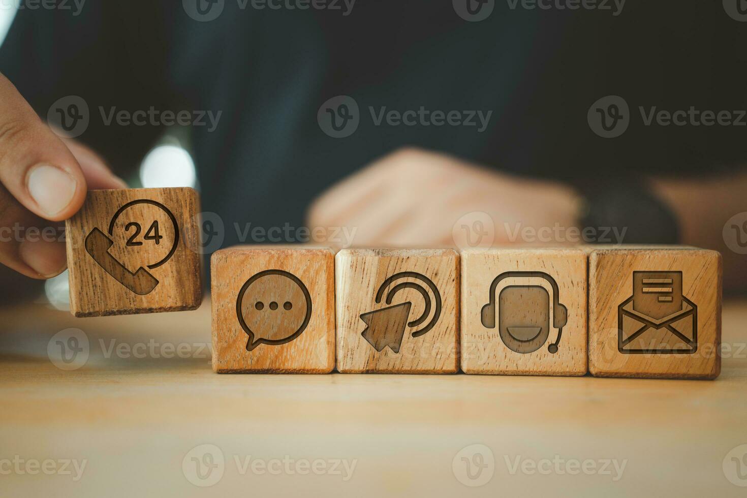 Businessman hand choose wooden block cube symbol icon contact us. photo