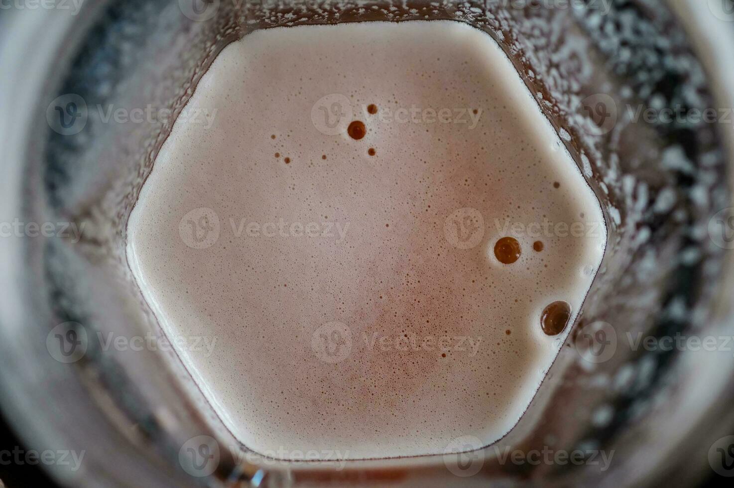 Beer with bubble foam on glass photo