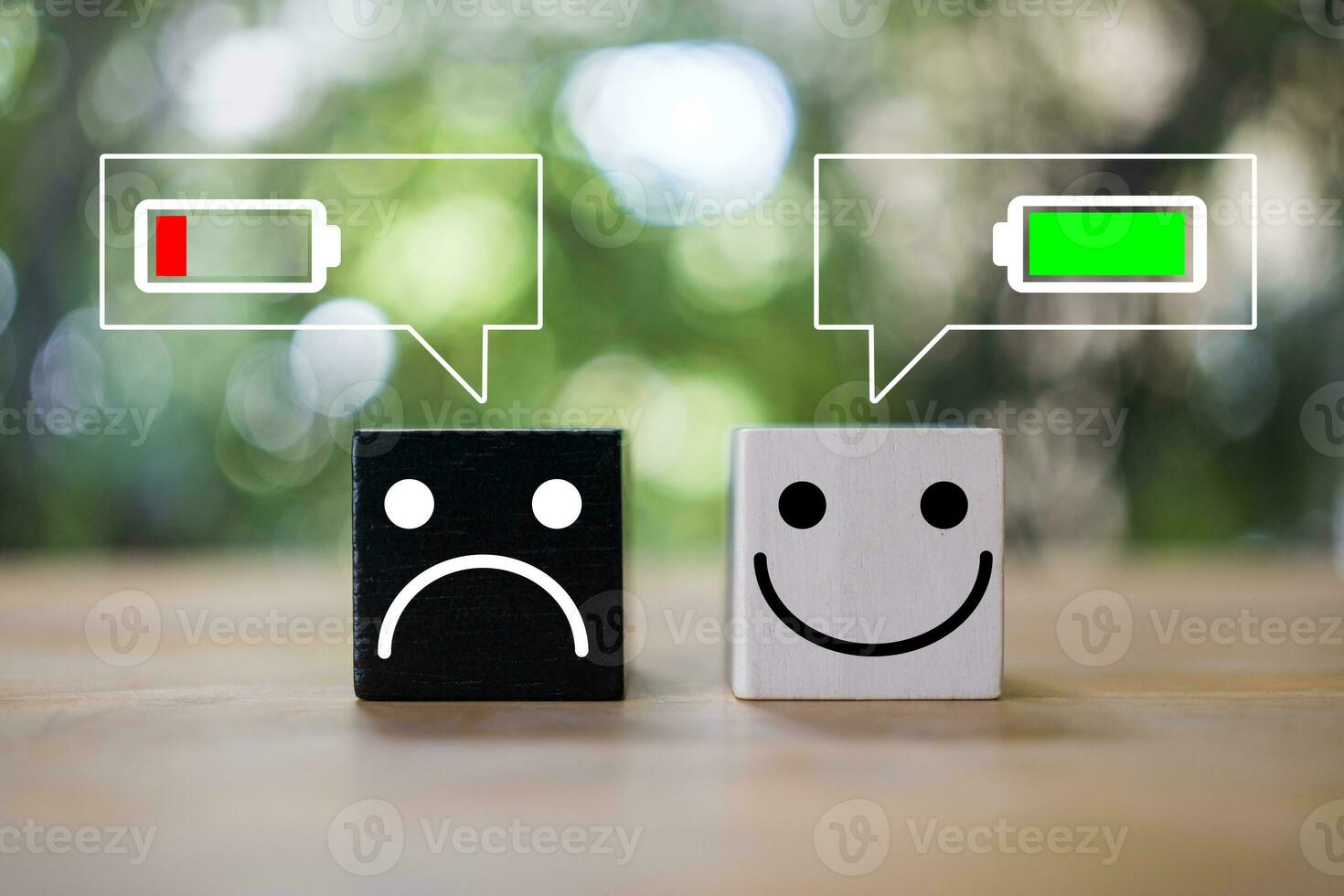 Happy and angry face on wood block with battery icon in message icon, happy workplace photo
