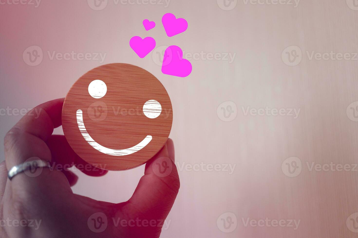 Hand holding icon smile face with many heart icons, positive thinking. photo