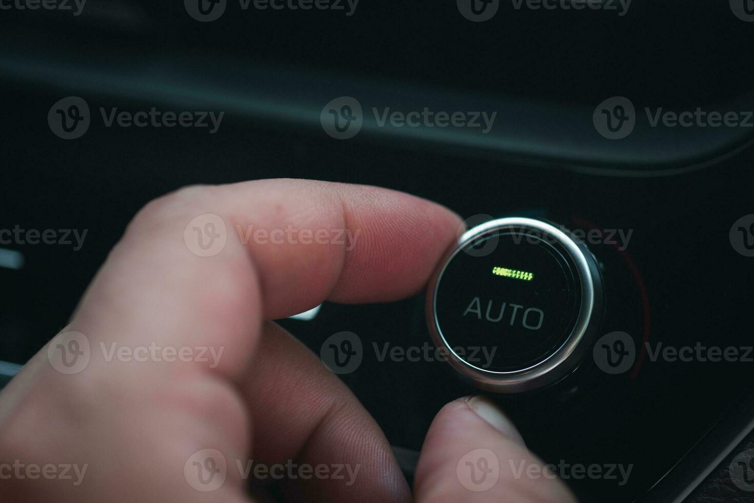Hand adjusting the air conditioner button in the car 30207511 Stock
