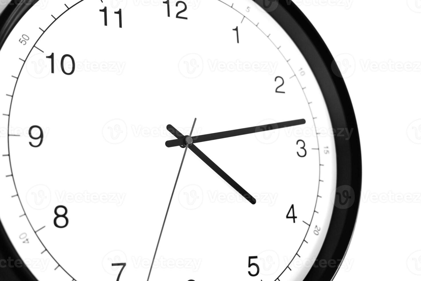 Part of analogue plain wall clock on white wall background. Four o'clock twelve minutes. Close up with copy space, timing, time management, opening hours time, school concept and lunch time. photo