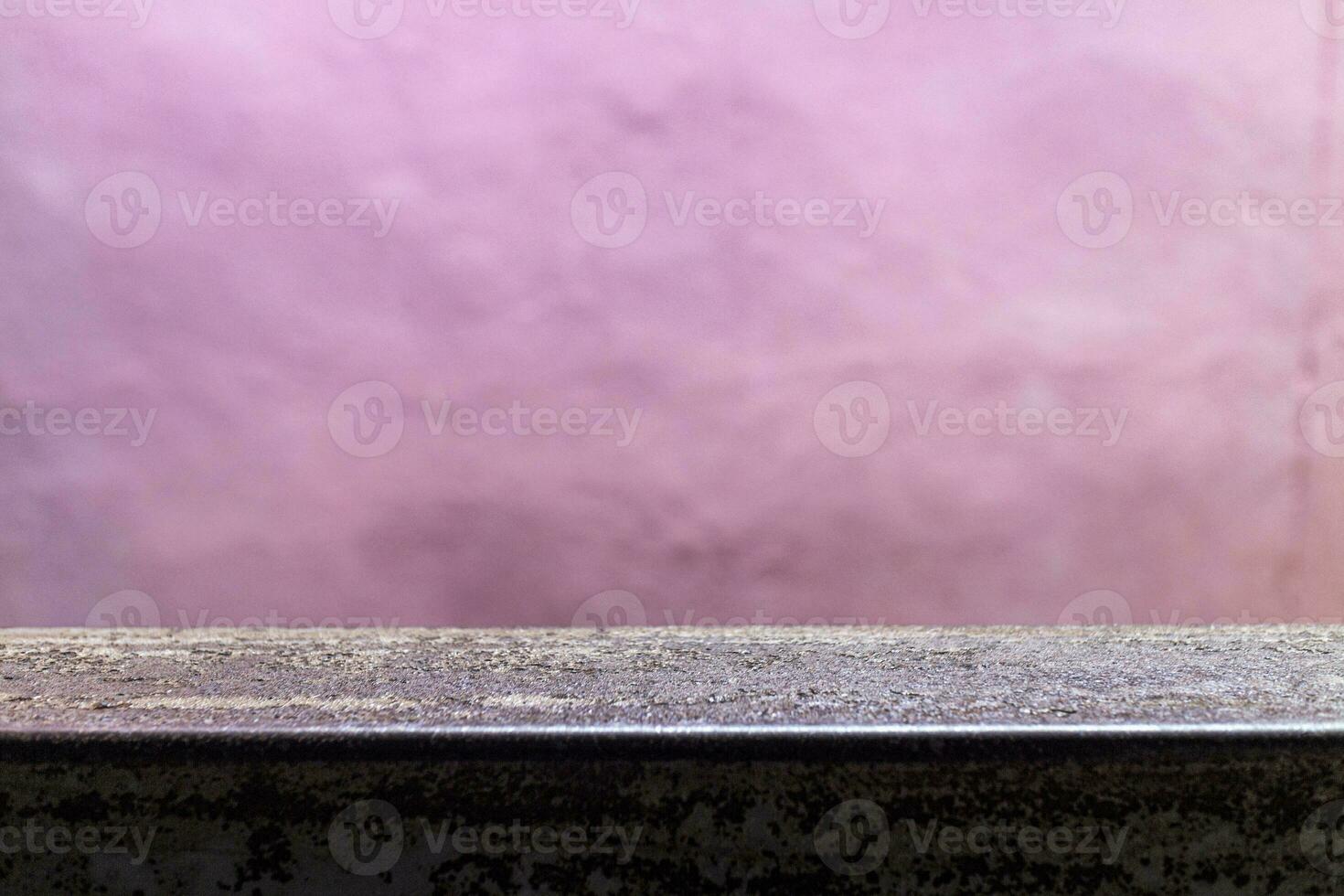 blank space metal plate for product display against blurred pink wall backdrop photo