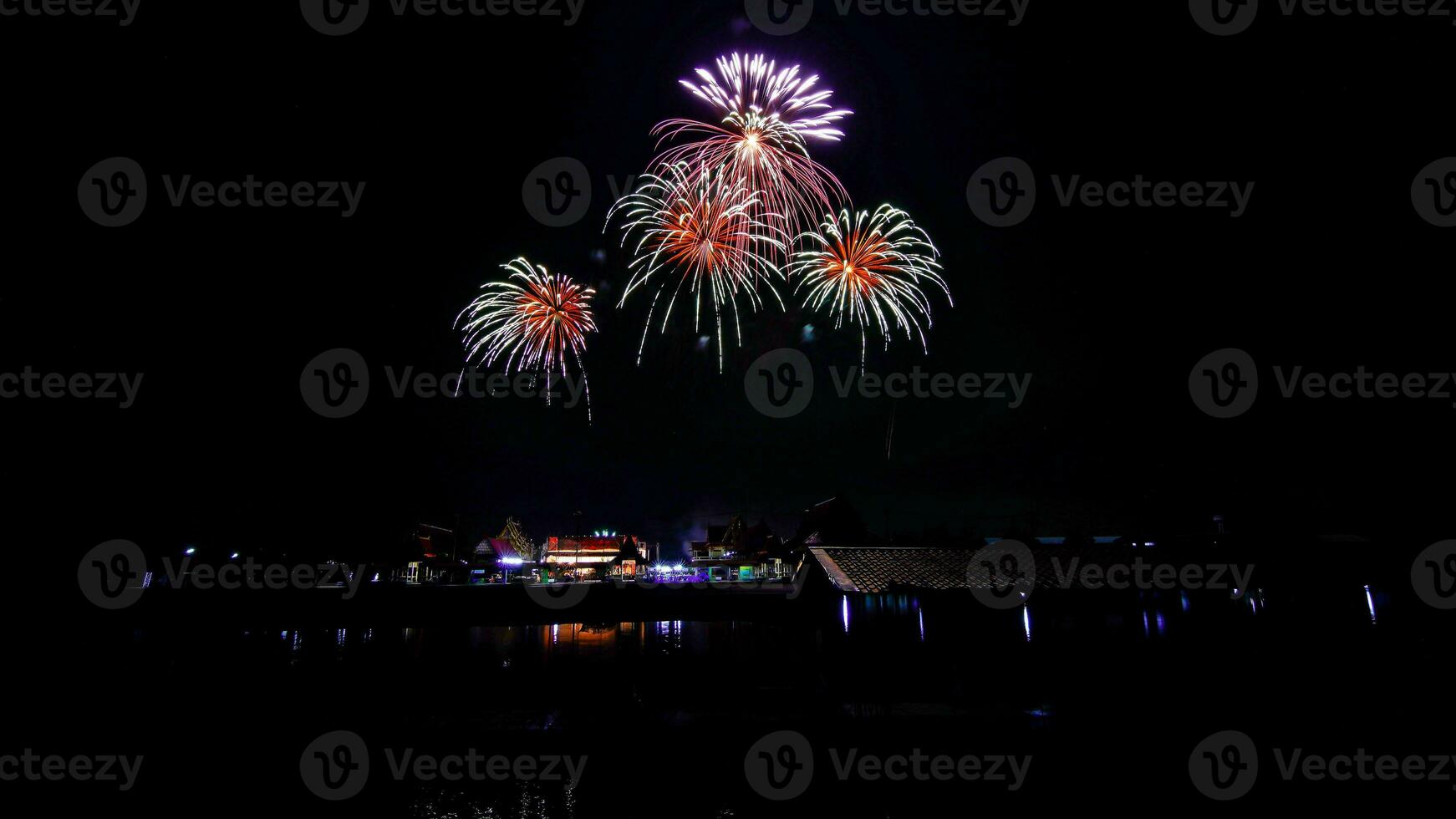 fireworks over the temple in the dark sky photo