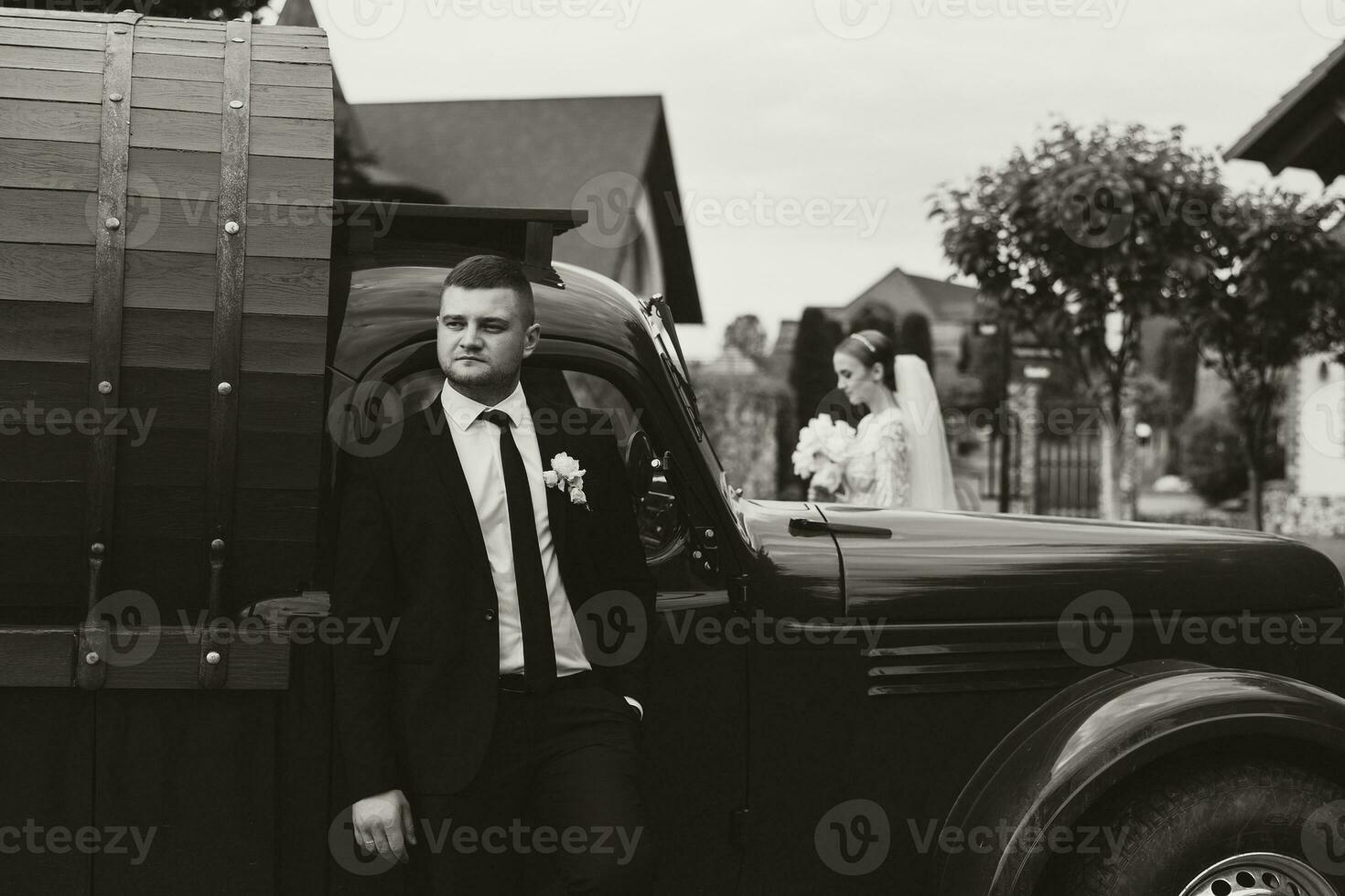 Happy bride and groom after wedding ceremony. Stylish groom. Adult groom. The groom in the foreground photo